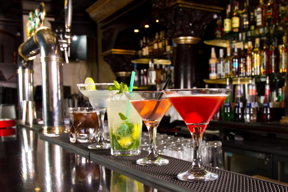 Five cocktails waiting at bar stool, bars in the foodservice industry