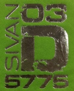 Custom silver foil "flaking" off of a lime green napkin